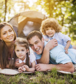 Young parents with their little children enjoying in family camping.

[url=http://www.istockphoto.com/search/lightbox/9786778][img]http://dl.dropbox.com/u/40117171/family.jpg[/img][/url]